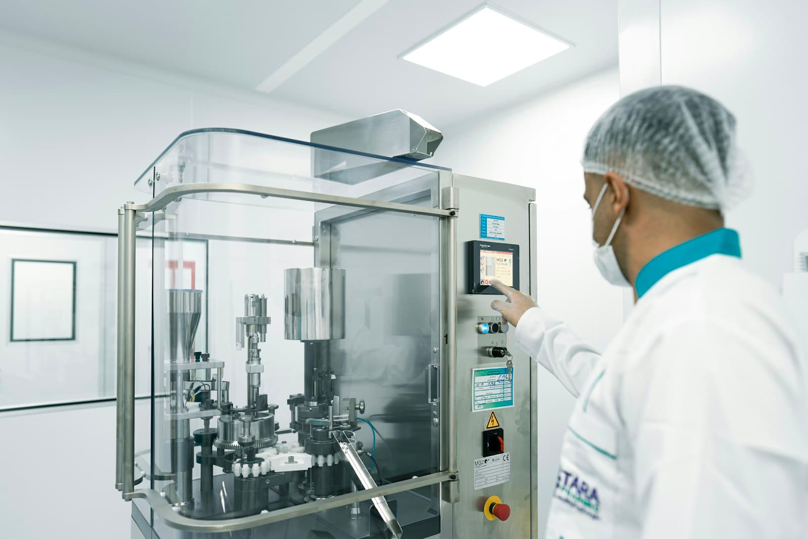 Operator working at pharmaceutical production equipment